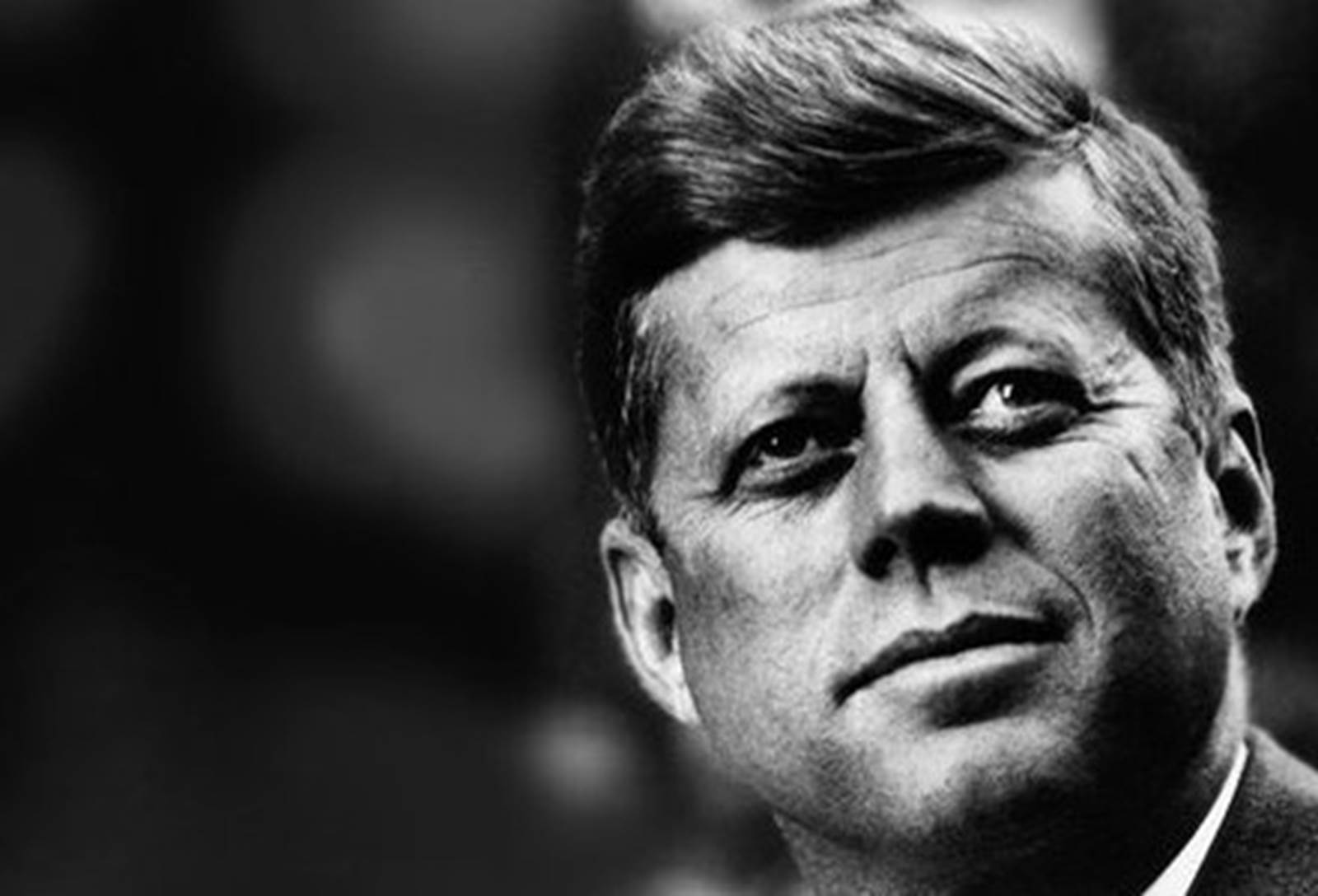 President John F. Kennedy looks upward.