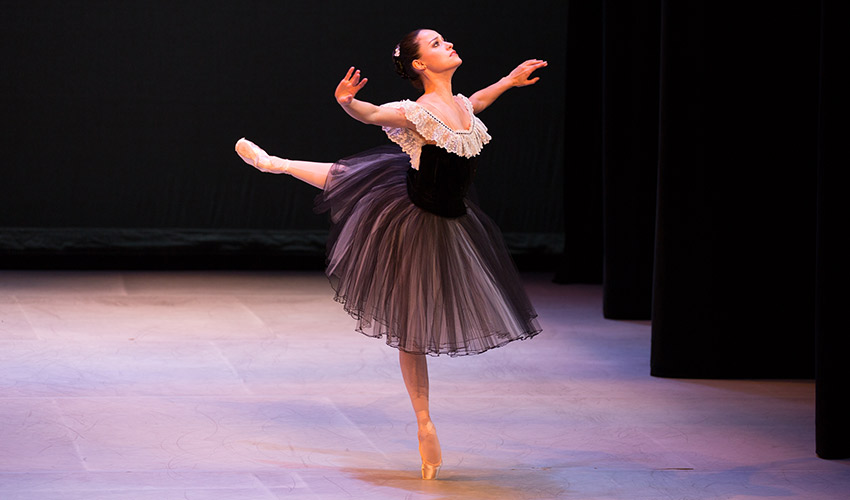 Natalia Magnicaballi doing an arabesque in Mozartiana