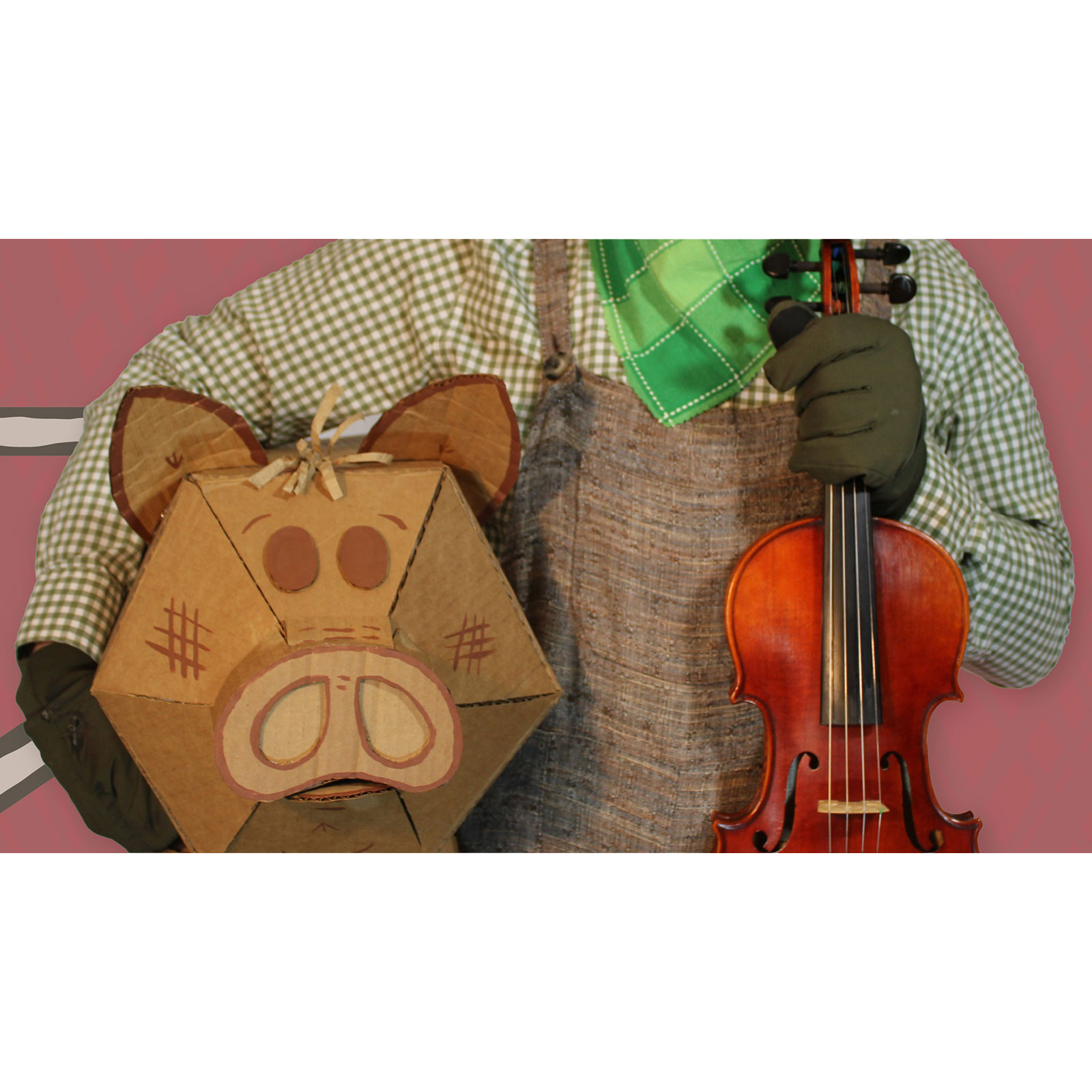 An image of a performer in a brown checkered shirt, brown overalls, green printed necktie, and gloves holds the neck of a violin in one hand and carries a stylized cardboard pig under their other arm. 