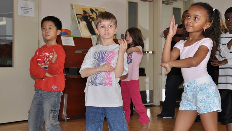 Three young students dance