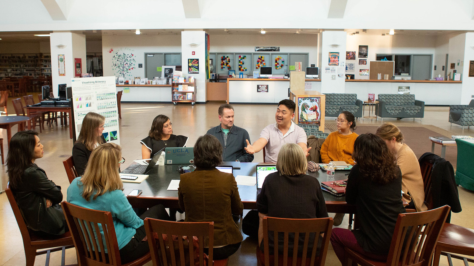 a group of educators sitting at a table inside a library.jpg