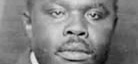 A black-and-white photo of activist Marcus Garvey.