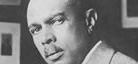 A black-and-white photo of writer James Weldon Johnson.