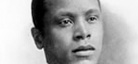 A black-and-white image of filmmaker Oscar Micheaux.