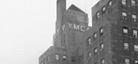 A black-and-white photo of the top of the Harlem YMCA building.