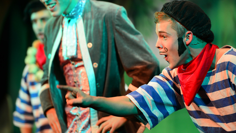 An actor pantomiming on stage. 