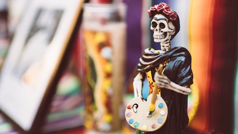 A Día de los Muertos skeleton on an altar. 