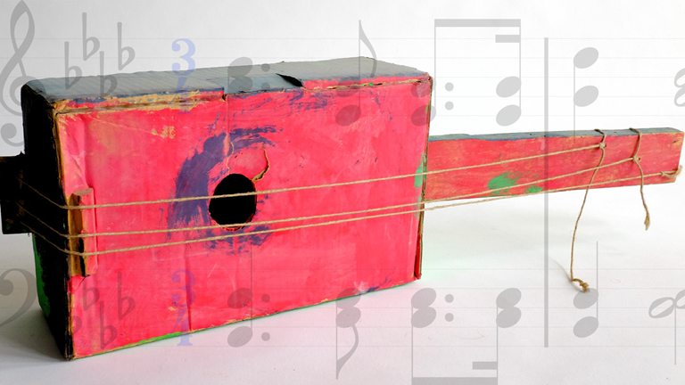 A homemade guitar made out of cardboard.