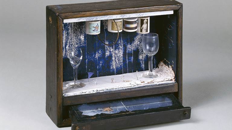 An identity by Joseph Cornell titled, Blue Soap Bubble. The objects in the box are symbols of the artists' childhood memories. For example, the blue-painted drawer represents the sea. The four cylinders represent his four family members