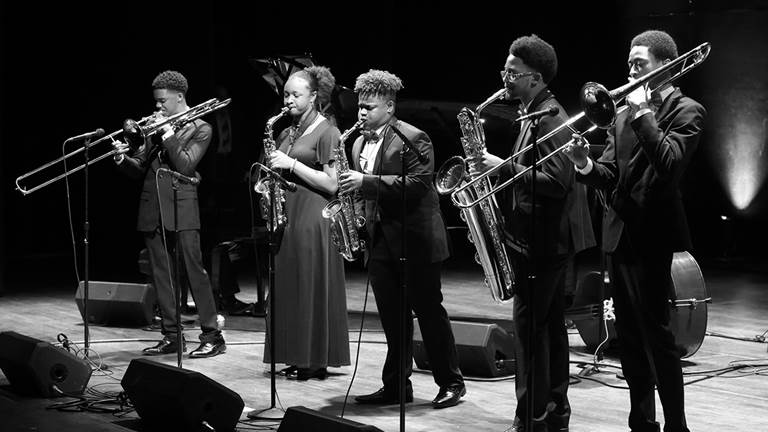 A black and white photo of a jazz band playing at the Kennedy Center.