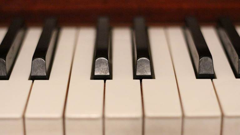 A close-up photograph of seven piano keys. 