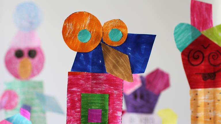 Colorful paper puppets made of different 2-D shapes. 