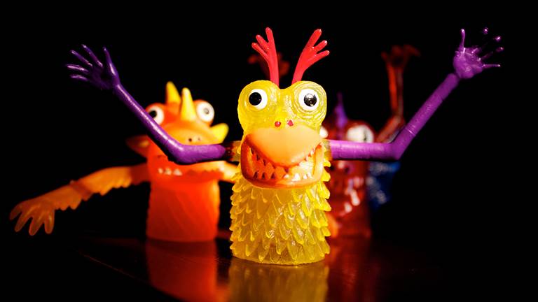 A yellow finger puppet monster. 