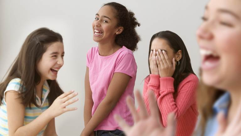 Students laughing and engaging with one another. 