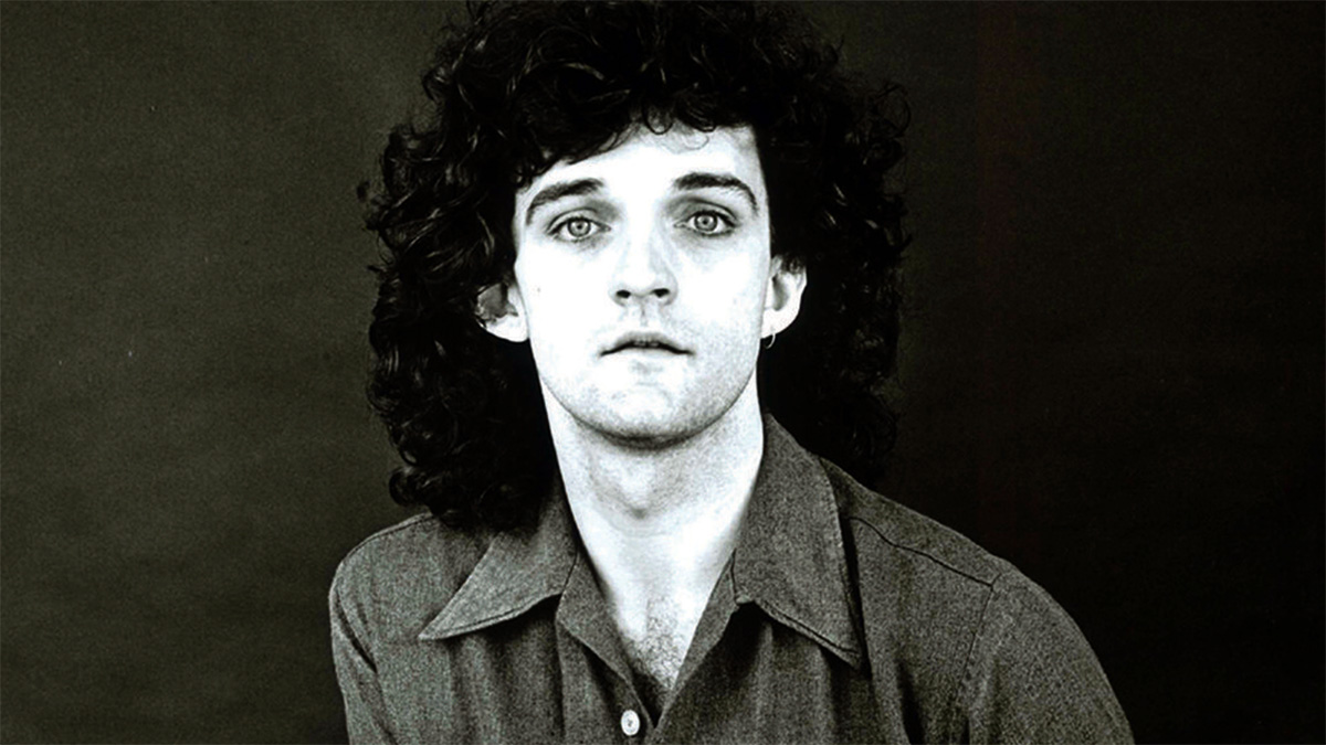 A black and white headshot of a man looking into the camera.