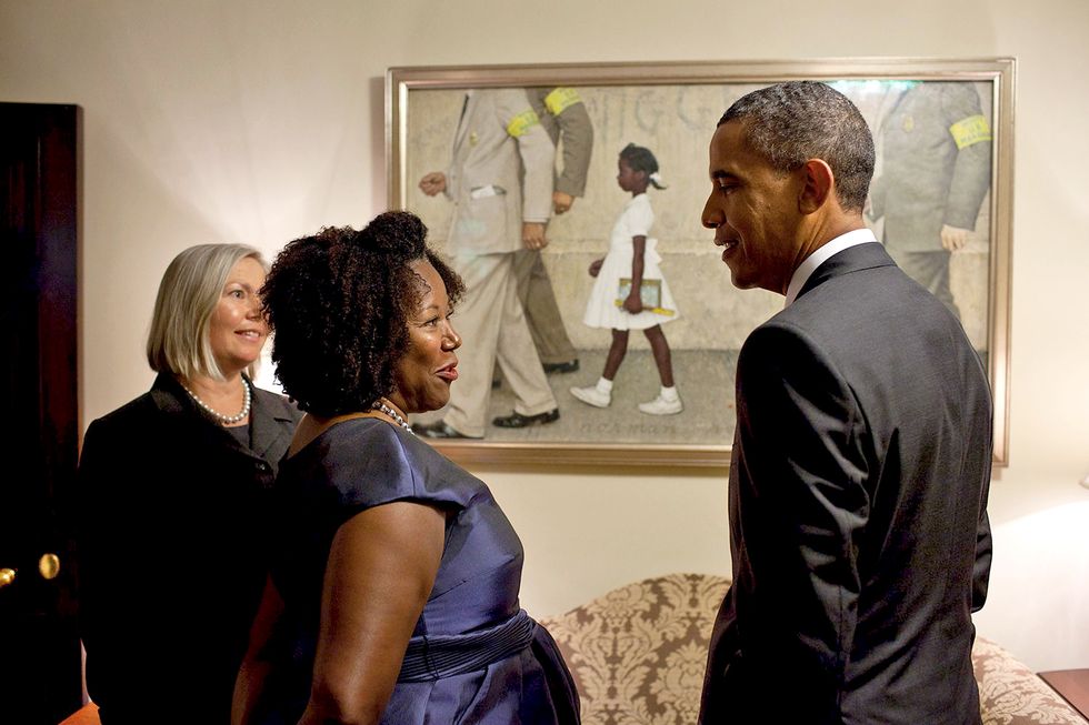 President Barack Obama stands with Ruby Bridges in front of the painting with Director/CEO of the Norman Rockwell Museum