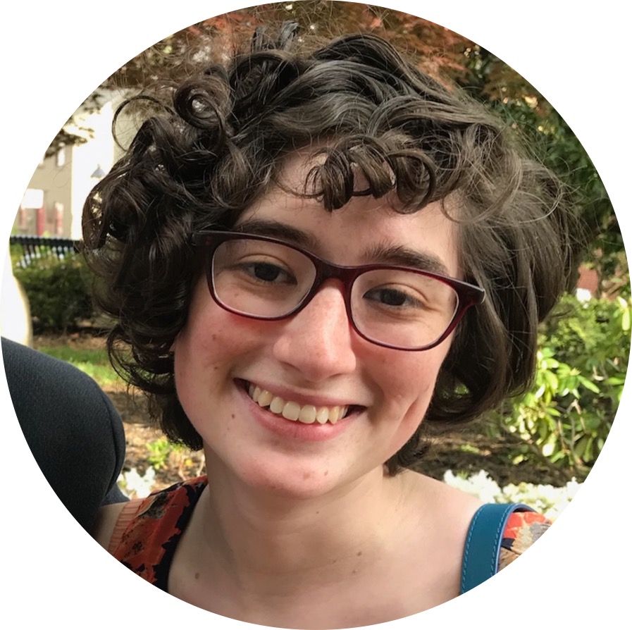 Joanna McKee, a white woman with short curly hair is smiling.