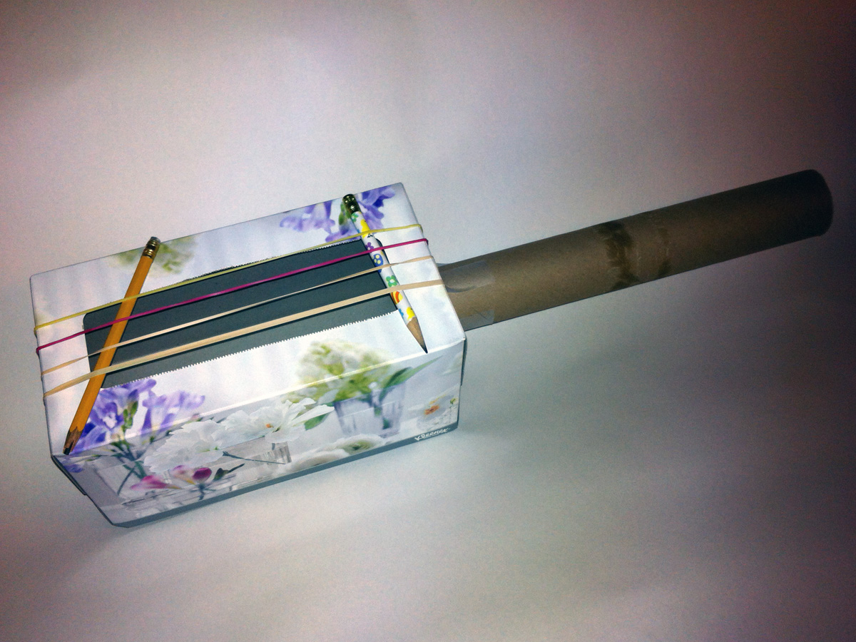 A photo of a completed do-it-yourself tissue box guitar.
