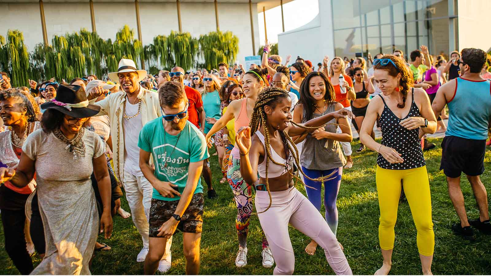 A group of young adults dancing  with Ebony ourdoors at the Kennedy Center 