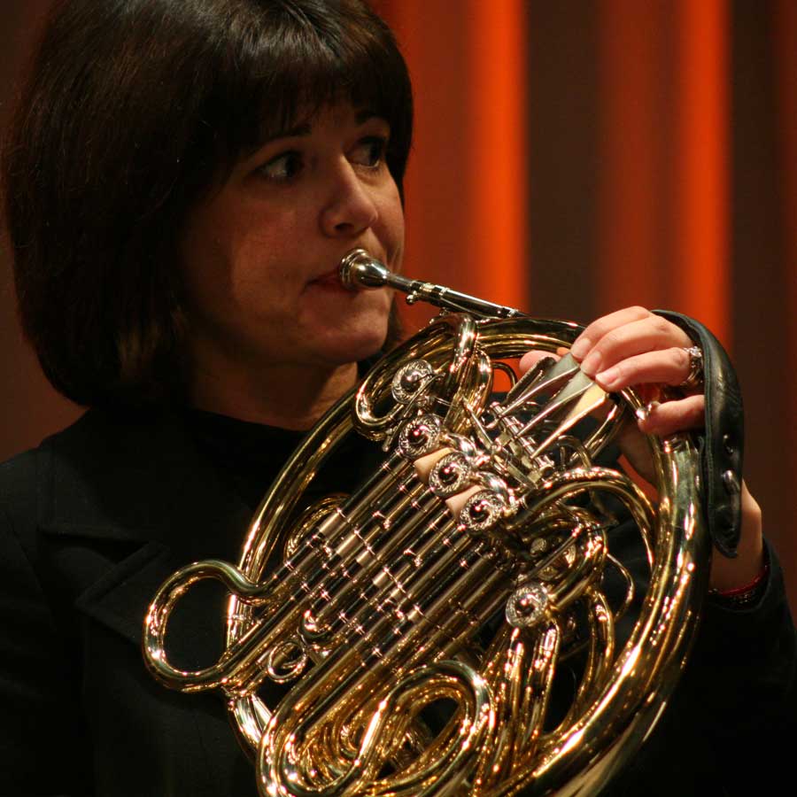 A musician playing the French Horn.