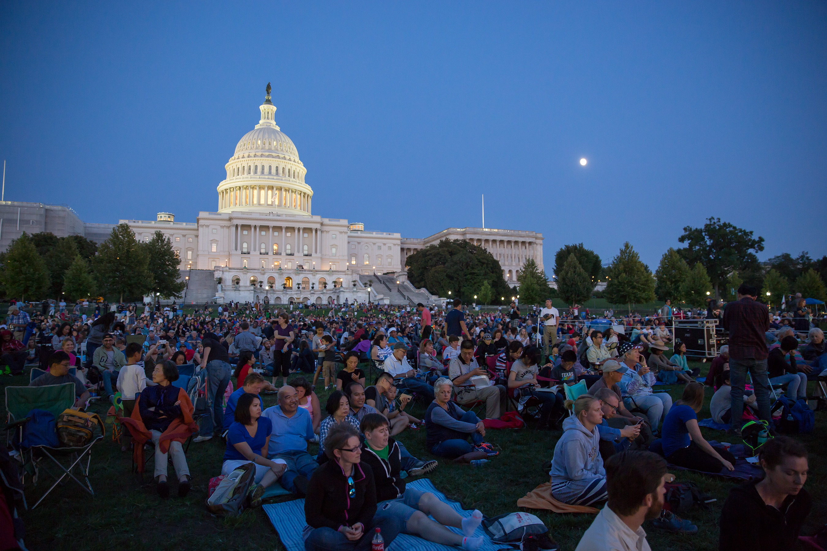 An audience sitting in front of the US Capital while listening to the National Symphony Orchestra