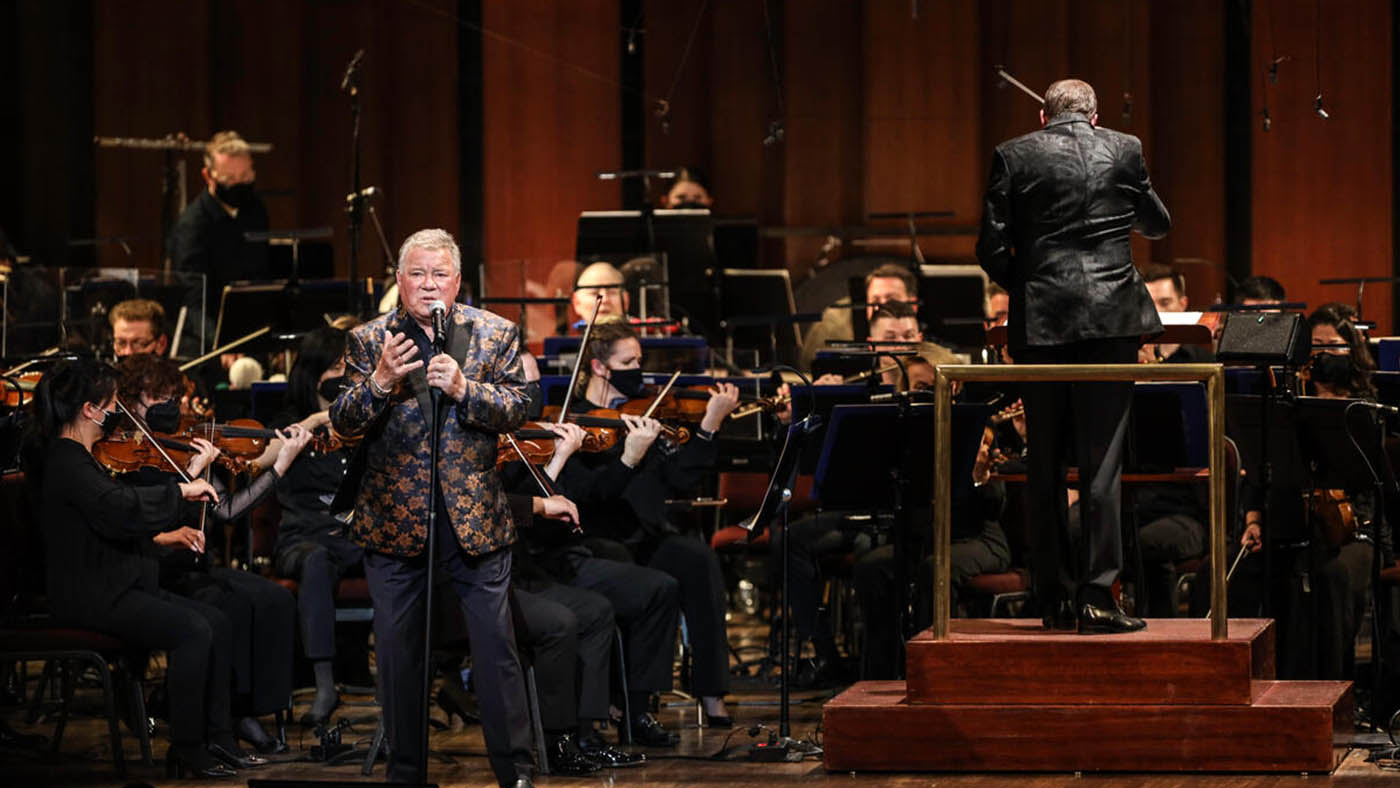 William Shatner singing with NSO while Steven Reineke  is conducting.
