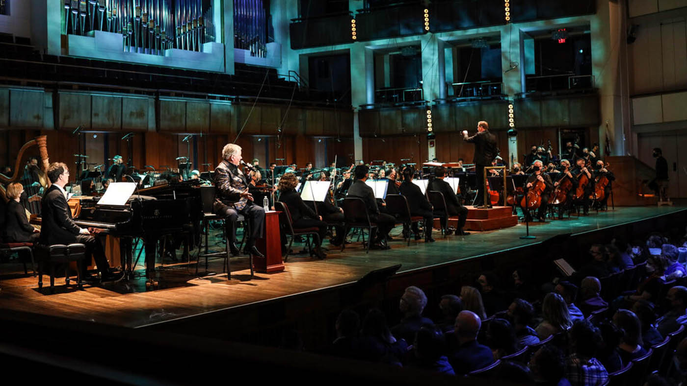 Steven Reineke conducting the NSO while William Shatner and Ben Folds are performing.