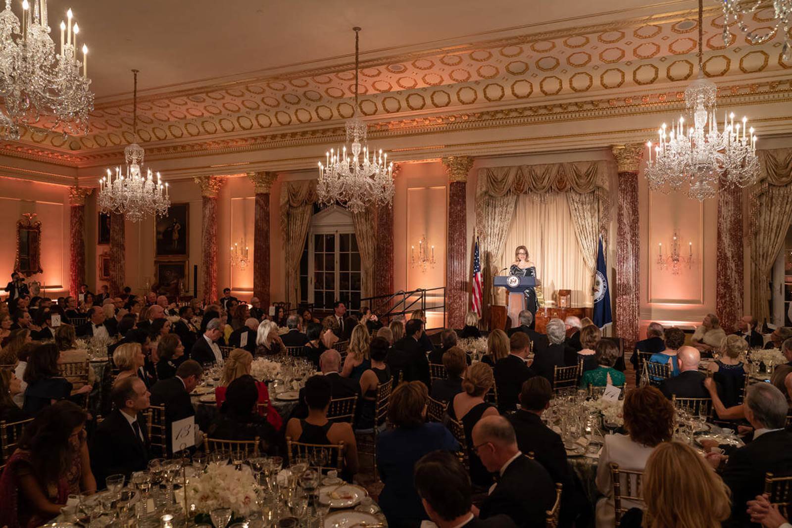 A woman addresses a crowd from a podium