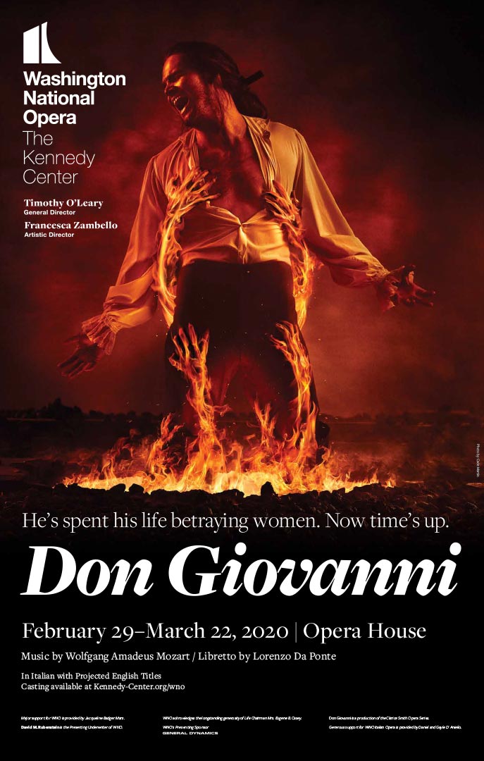 A screaming man stands in a fiery pit as flaming demonic hands tear at his clothes