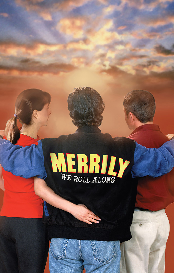 A young woman and two young men with their backs to the viewer hug each other as they watch a sunset