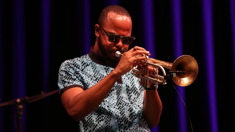 A man plays the trumpet.