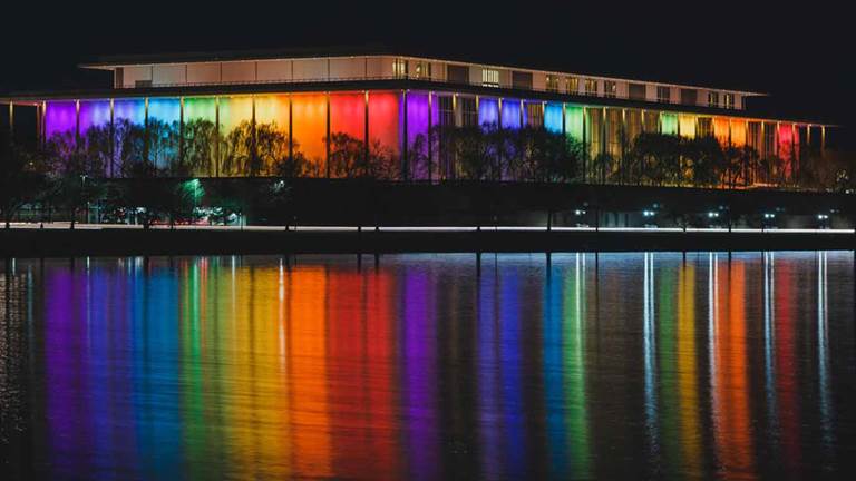 Kennedy Center building during Honors with rainbow lights.