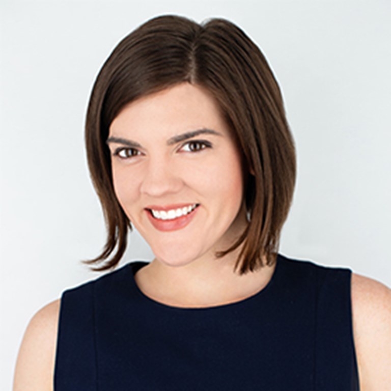 Farrell Parker smiling and tilting her head down to help show of her bob  hair cut